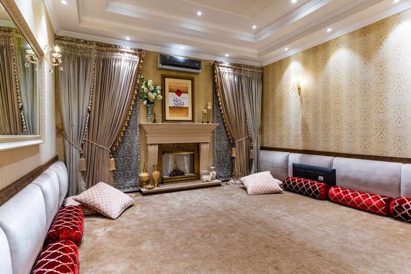 Elegant traditional living room with a fireplace and a warm patterned wall